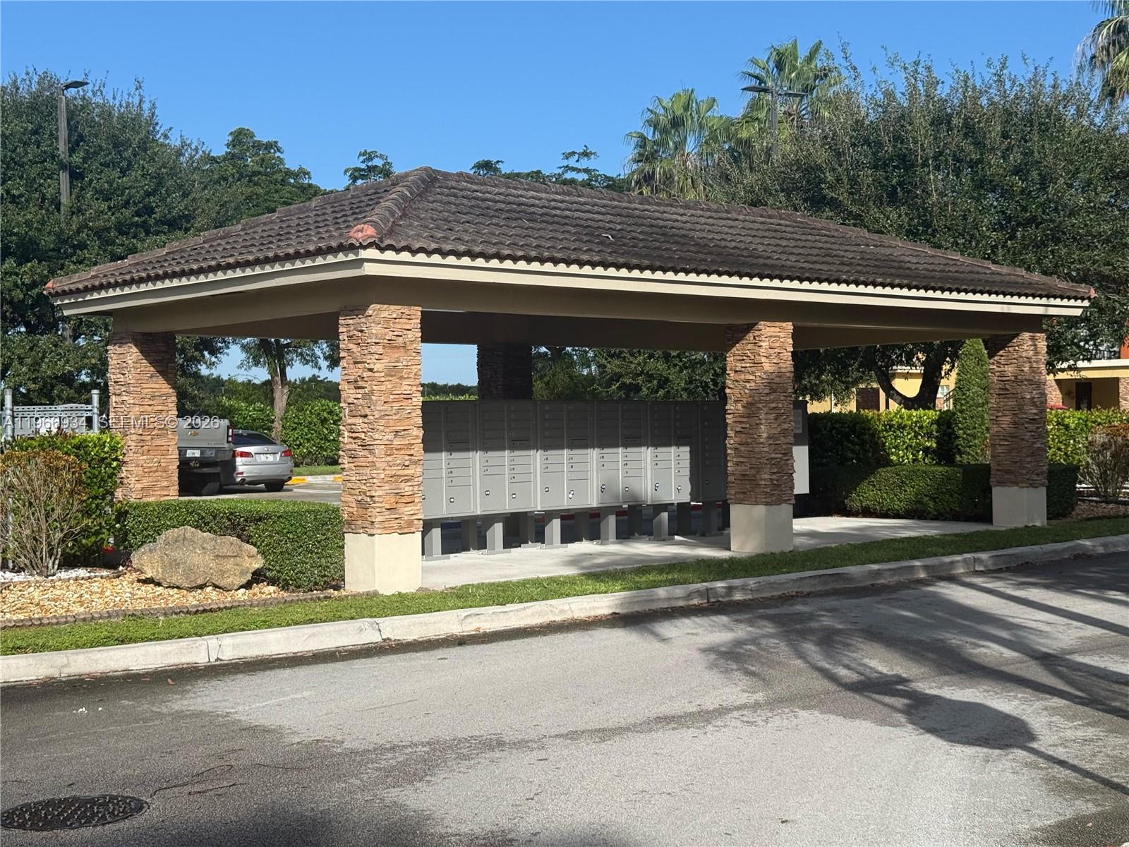 930 Northeast 34th Avenue, Unit 201 Homestead, FL 33033 - Photo 4 of 26 a front view of a house with a yard