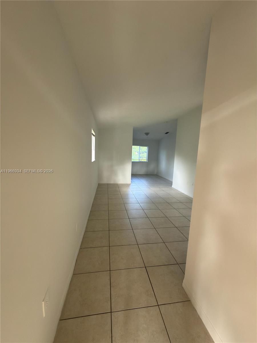 930 Northeast 34th Avenue, Unit 201 Homestead, FL 33033 - Photo 6 of 26 a view of an empty room and window