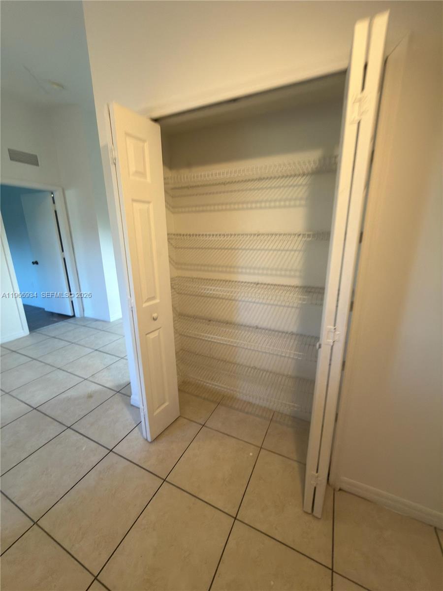 930 Northeast 34th Avenue, Unit 201 Homestead, FL 33033 - Photo 7 of 26 a bathroom with a shower and a sink