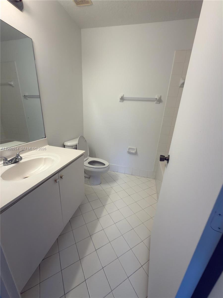 930 Northeast 34th Avenue, Unit 201 Homestead, FL 33033 - Photo 8 of 26 a bathroom with a sink toilet and vanity