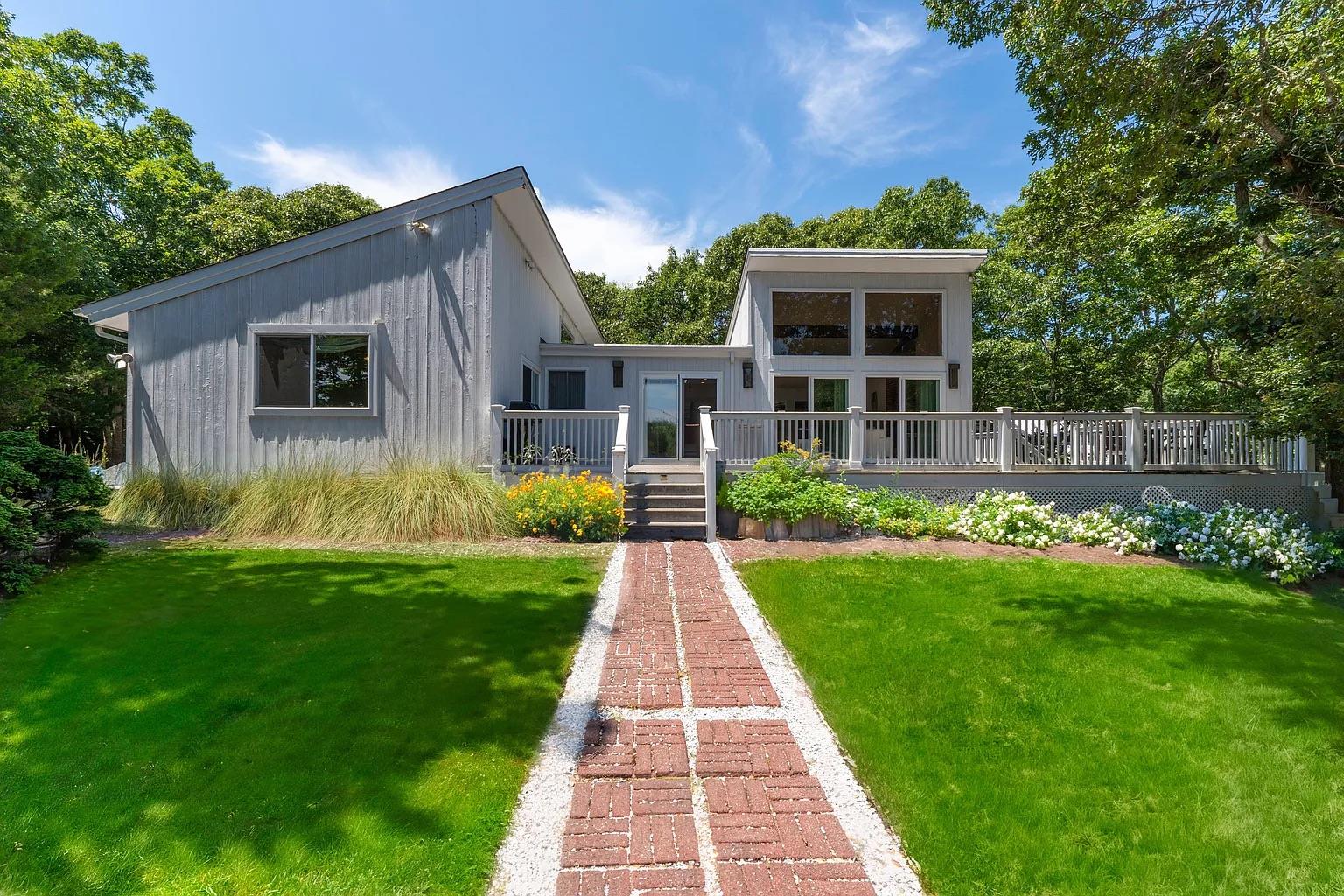 1 Monument Lane East Hampton, NY 11937 - Photo 1 of 1 a front view of house with yard and green space