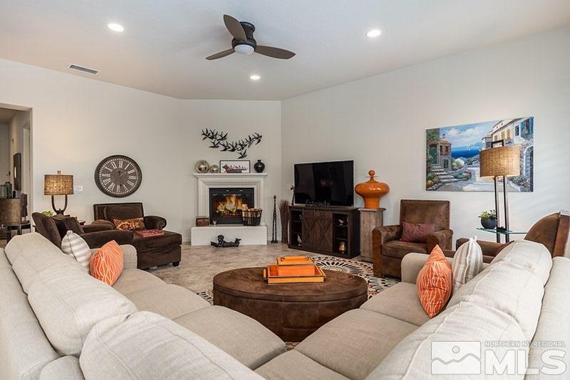 9285 Sassafras Trail Reno, NV 89523 - Photo 4 of 28 a living room with furniture ceiling fan and a flat screen tv