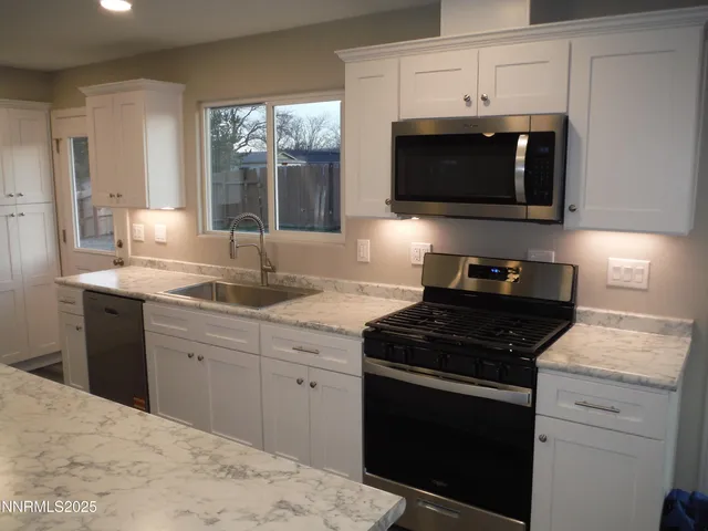 a kitchen with a sink stove and microwave