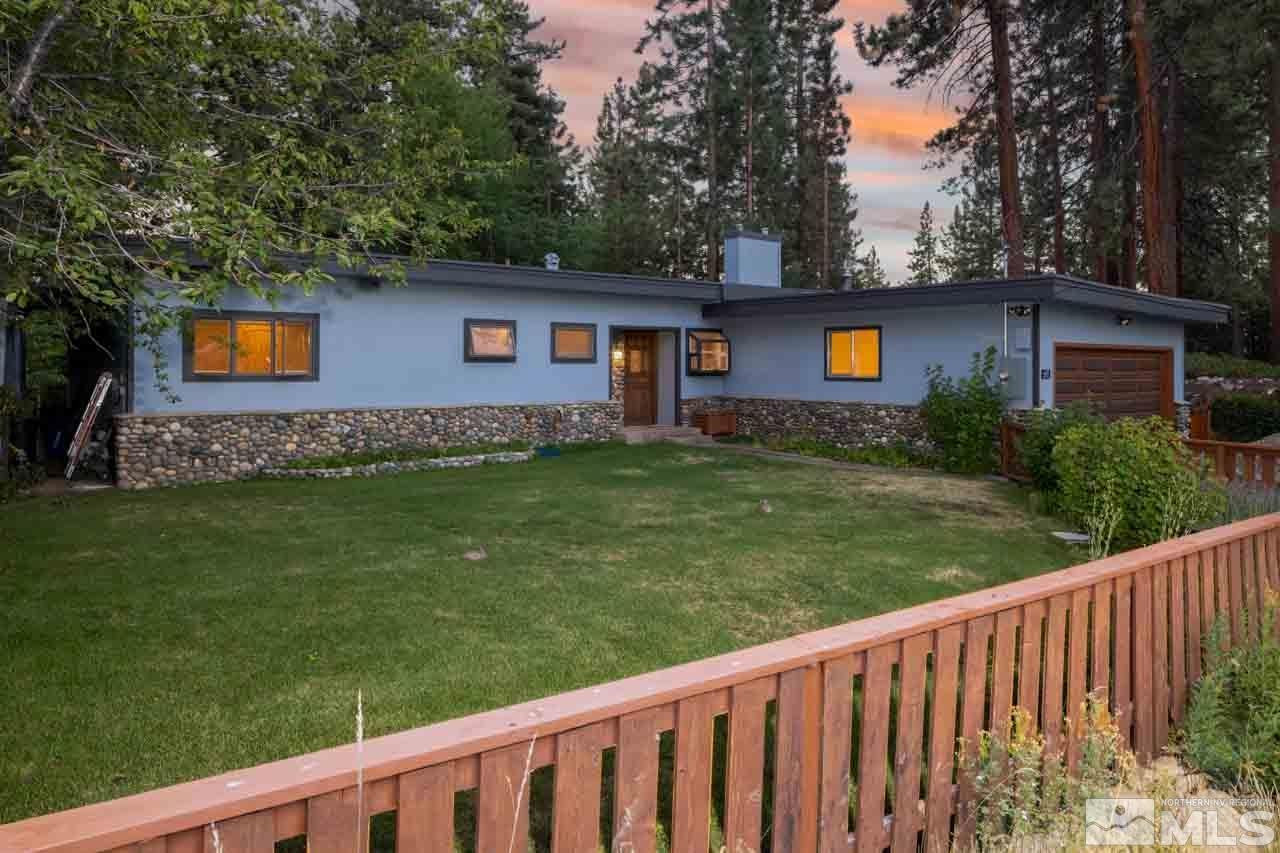 633 Riven Rock Road Zephyr Cove, NV 89448 - Photo 1 of 41 a view of a backyard with wooden fence and a tree