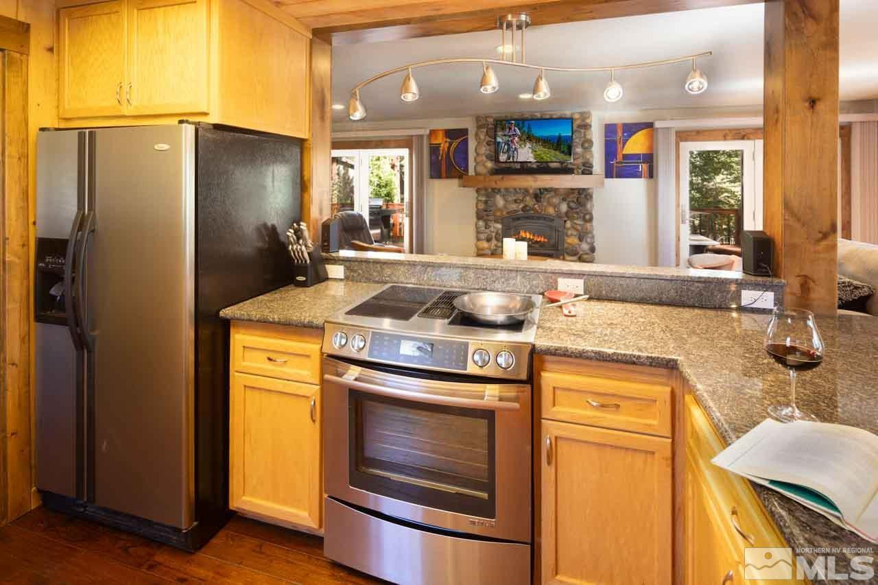 633 Riven Rock Road Zephyr Cove, NV 89448 - Photo 12 of 41 a kitchen with stainless steel appliances granite countertop a stove and a refrigerator