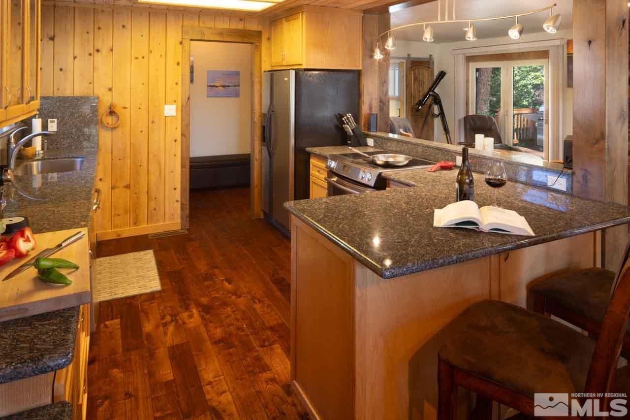 633 Riven Rock Road Zephyr Cove, NV 89448 - Photo 13 of 41 a kitchen with stainless steel appliances granite countertop a sink refrigerator and cabinets