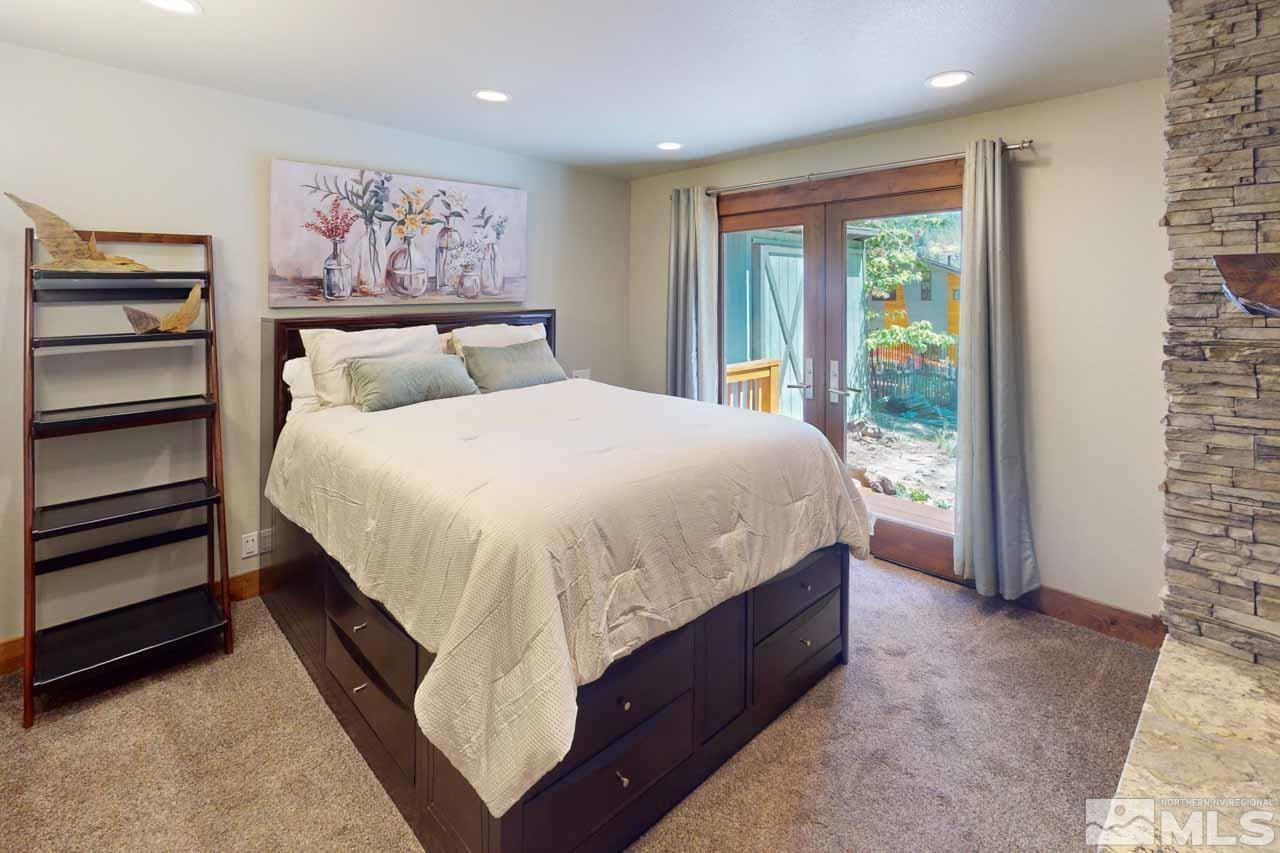 633 Riven Rock Road Zephyr Cove, NV 89448 - Photo 19 of 41 a large bed sitting in a bedroom next to a window