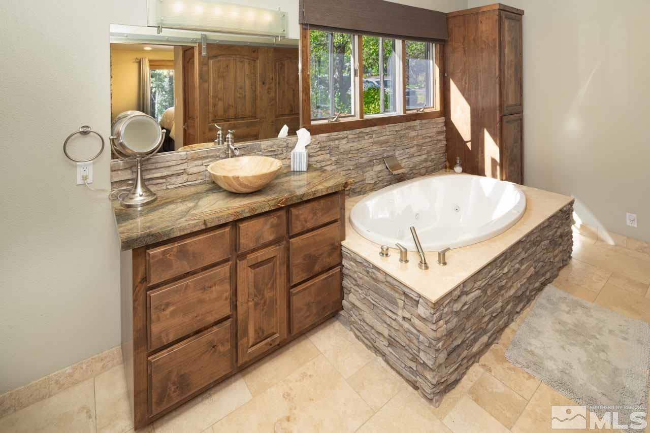 633 Riven Rock Road Zephyr Cove, NV 89448 - Photo 20 of 41 a spacious bathroom with a tub double sink and a large mirror