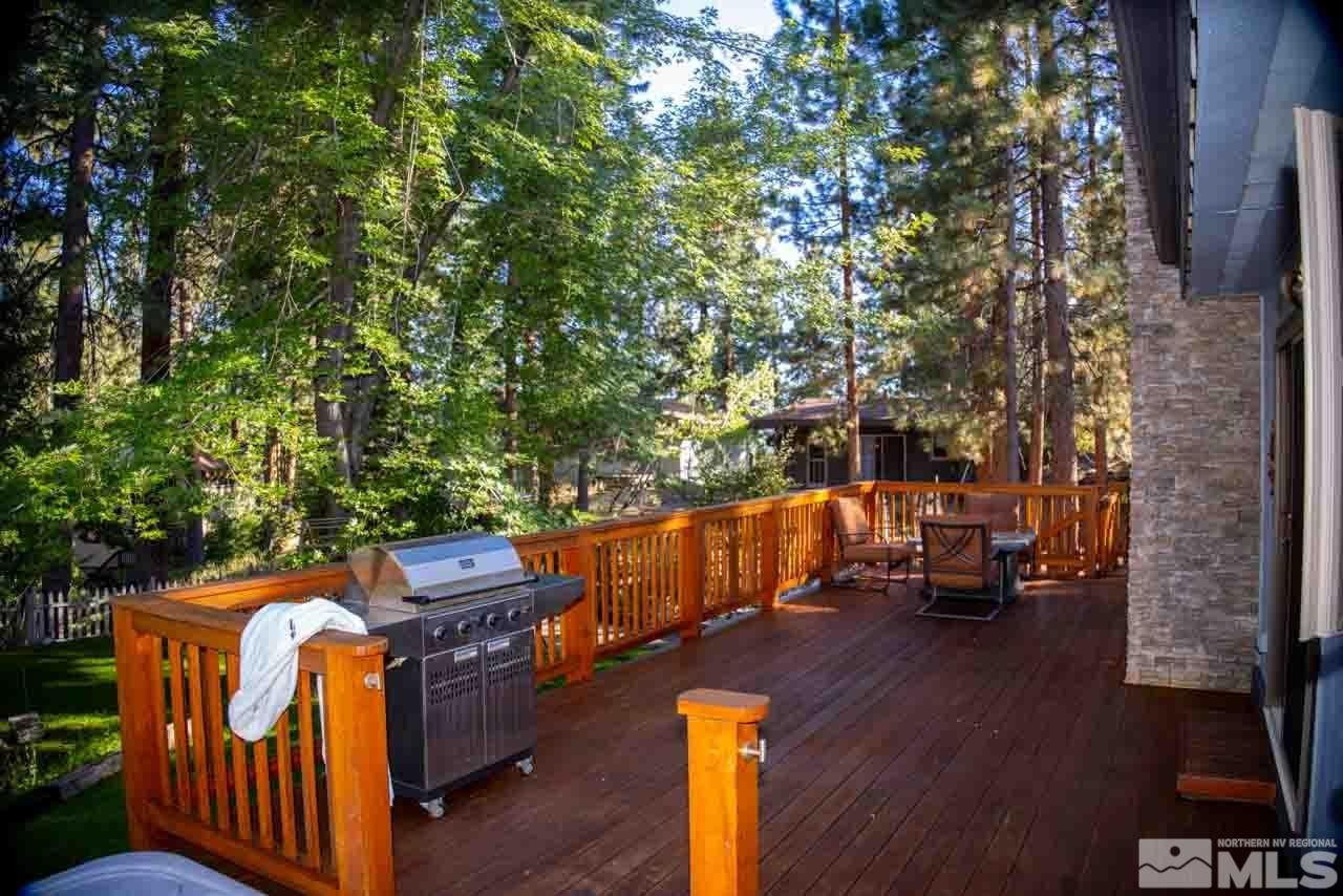 633 Riven Rock Road Zephyr Cove, NV 89448 - Photo 30 of 41 a backyard of a house with wooden floor and fence