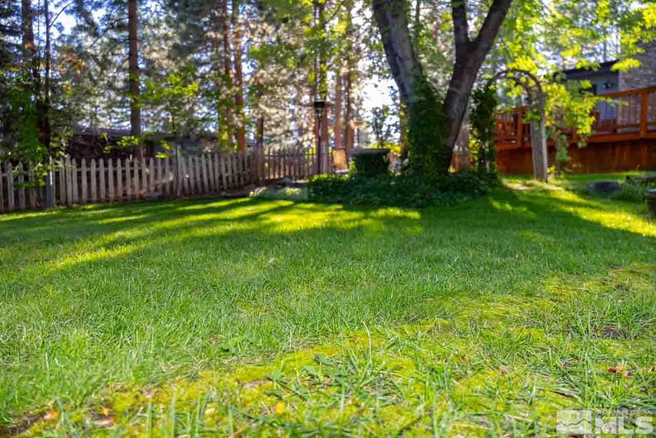 633 Riven Rock Road Zephyr Cove, NV 89448 - Photo 31 of 41 a view of a backyard with large trees and wooden fence
