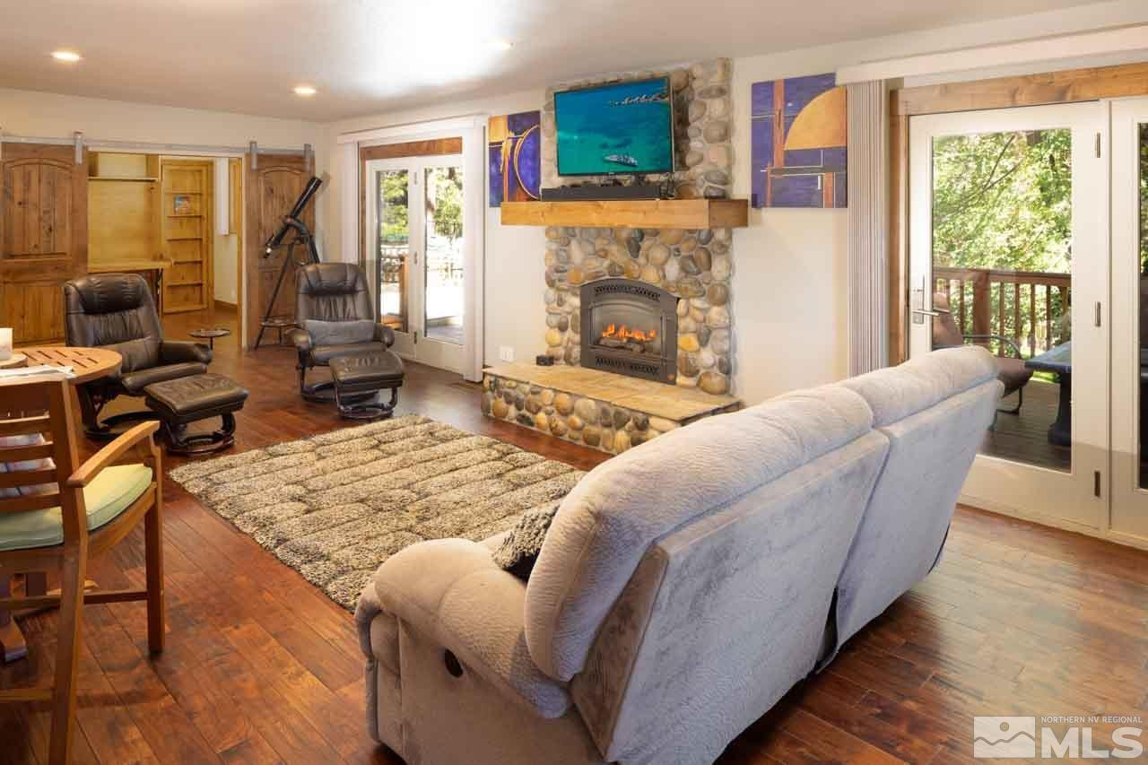 633 Riven Rock Road Zephyr Cove, NV 89448 - Photo 4 of 41 a living room with furniture large window and a fireplace