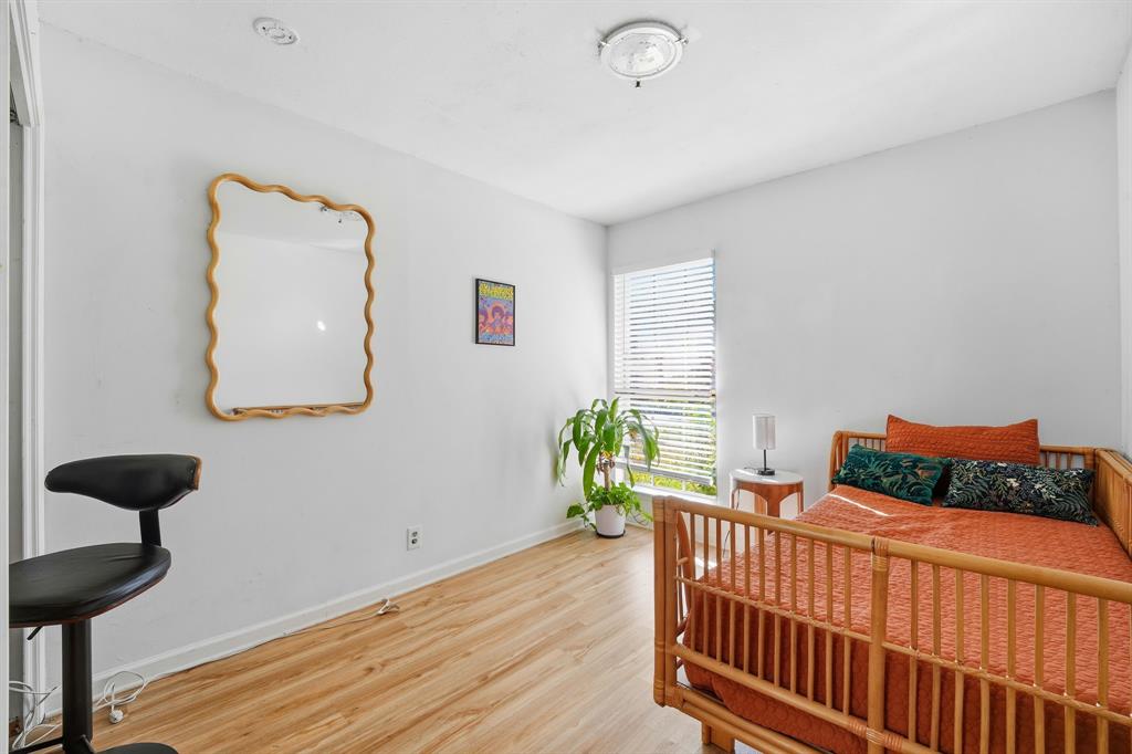802 Buckingham Place Austin, TX 78745 - Photo 11 of 21 a bedroom with furniture and a window