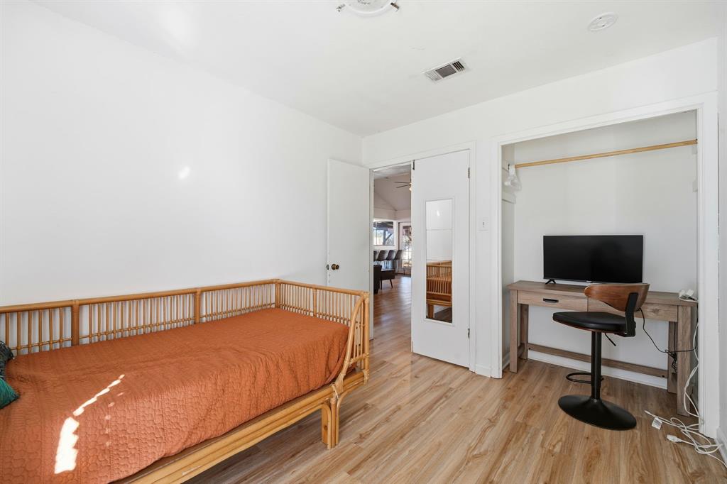 802 Buckingham Place Austin, TX 78745 - Photo 12 of 21 a bedroom with a bed and a flat screen tv