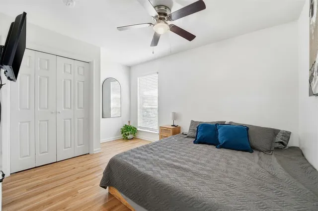 a bedroom with a bed and a flat tv screen