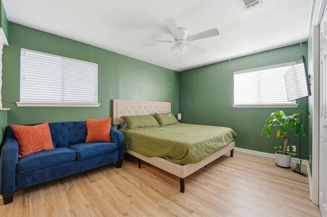 a bed sitting in a bedroom next to a window