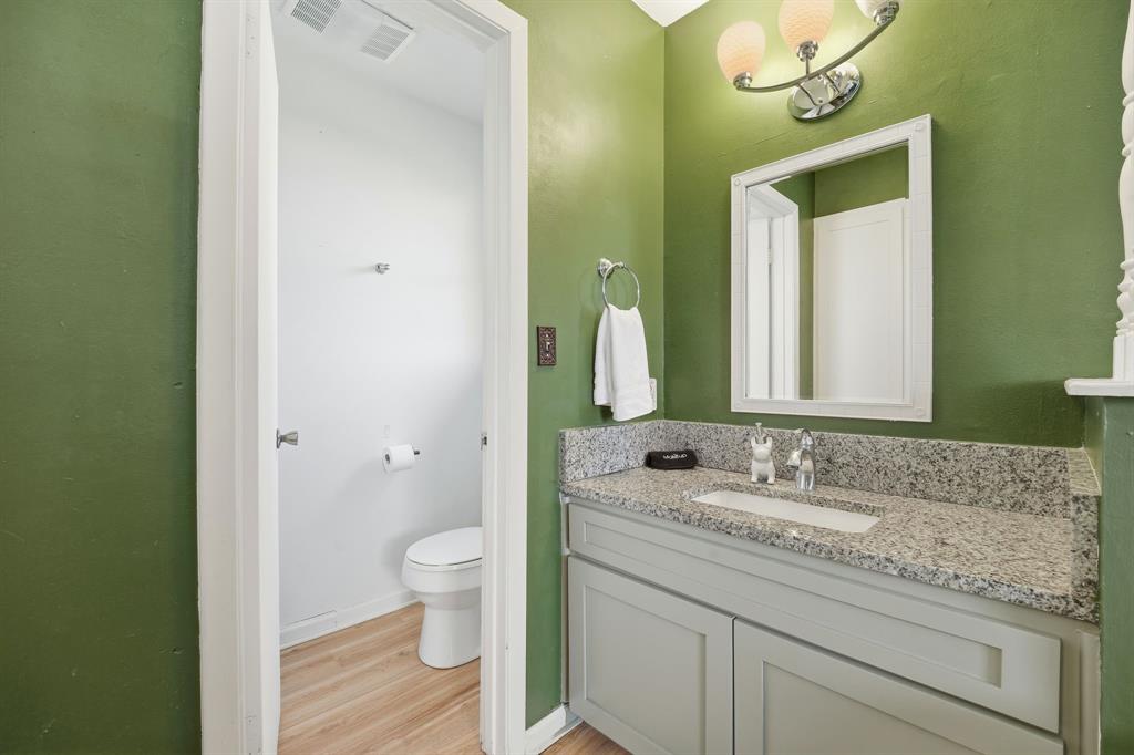 802 Buckingham Place Austin, TX 78745 - Photo 19 of 21 a bathroom with a granite countertop sink toilet and mirror