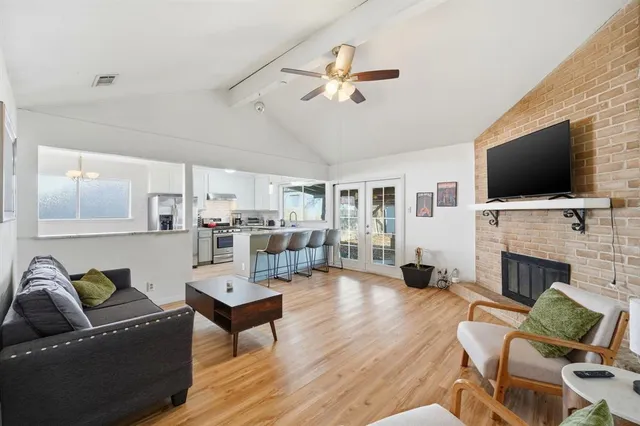 a living room with furniture fireplace and flat screen tv