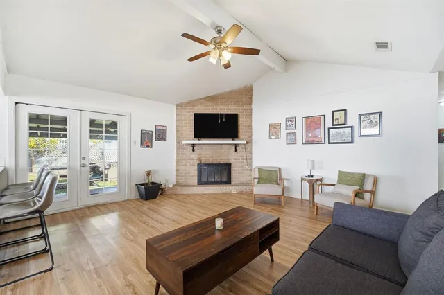 a living room with furniture a fireplace and a flat screen tv