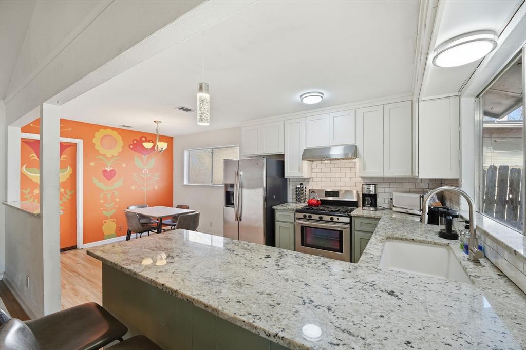 802 Buckingham Place Austin, TX 78745 - Photo 6 of 21 a kitchen with granite countertop a sink stove and refrigerator