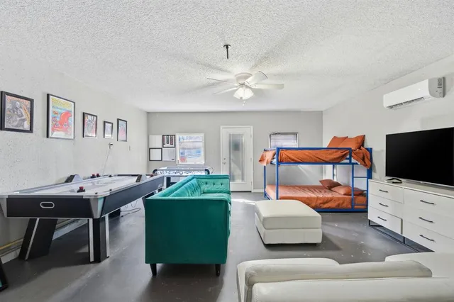 a bedroom with furniture and a flat screen tv