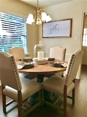 a view of a dining room with furniture and chandelier
