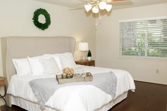 a bedroom with bed and a window