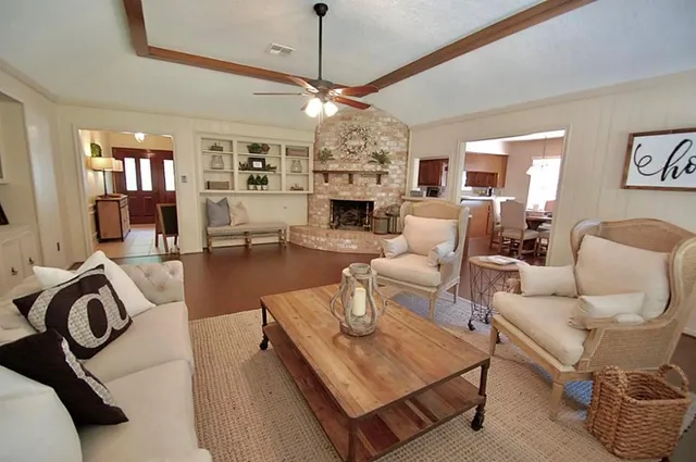 a living room with furniture a chandelier and a fireplace