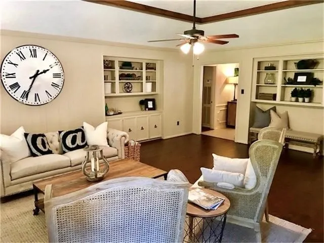 a living room with furniture and view of kitchen