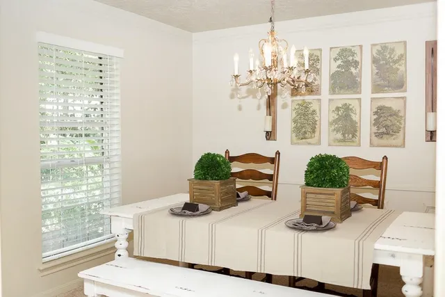 a view of a dining room with furniture a chandelier and wooden floor