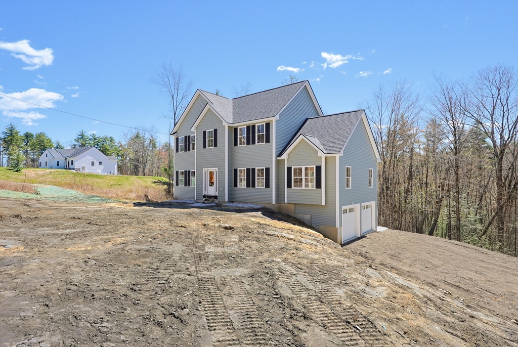 112 West Meadow Road Townsend, MA 01474 - Photo 37 of 38 a front view of a house with a yard and mountain view in back