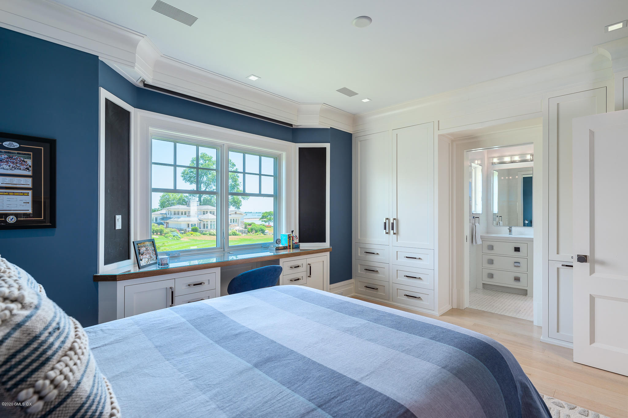 22 Pilot Rock Lane Riverside, CT 06878 - Photo 22 of 40 a bedroom with a large bed and a large window