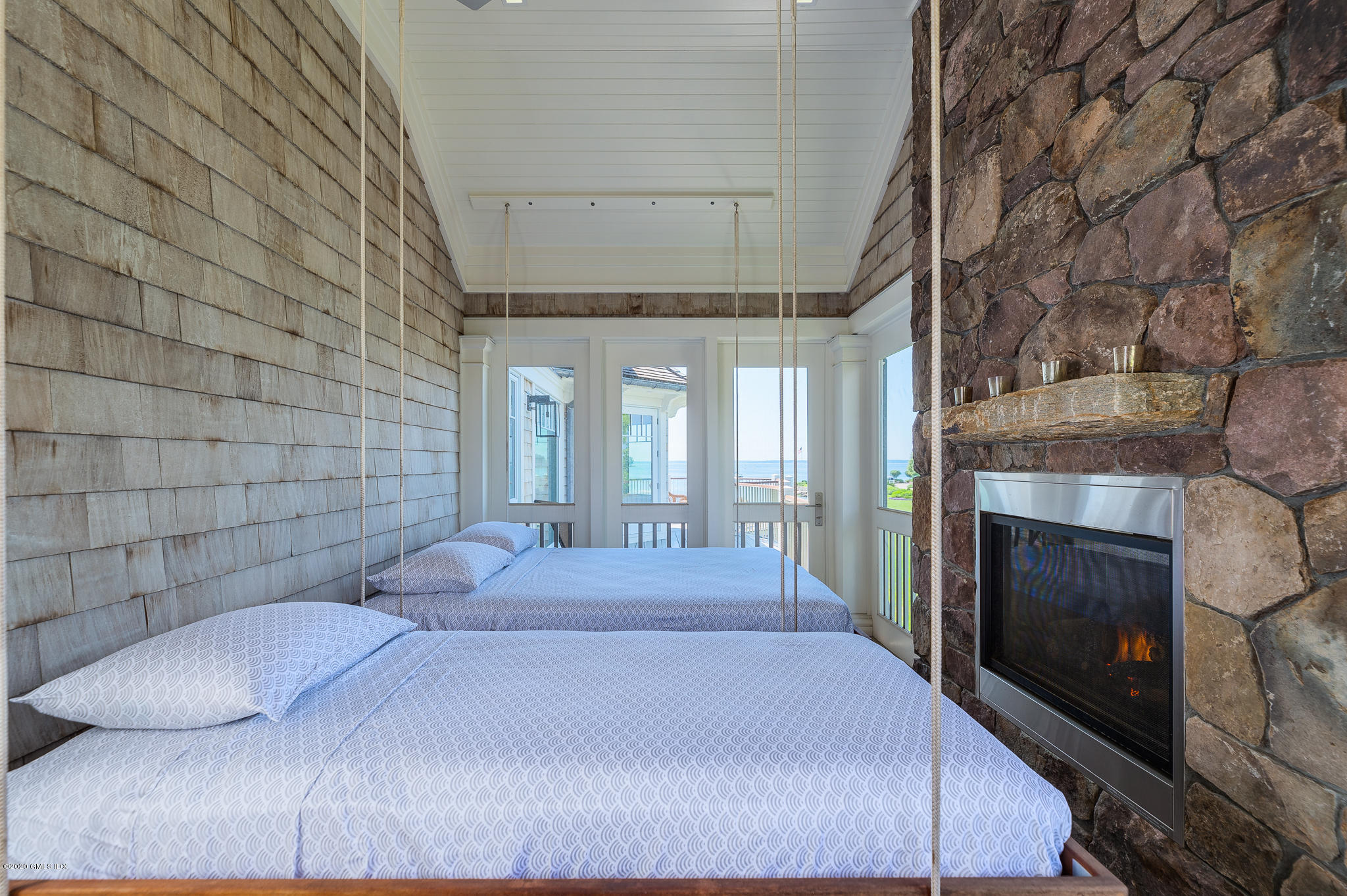 22 Pilot Rock Lane Riverside, CT 06878 - Photo 26 of 40 a bedroom with a bed and a fireplace