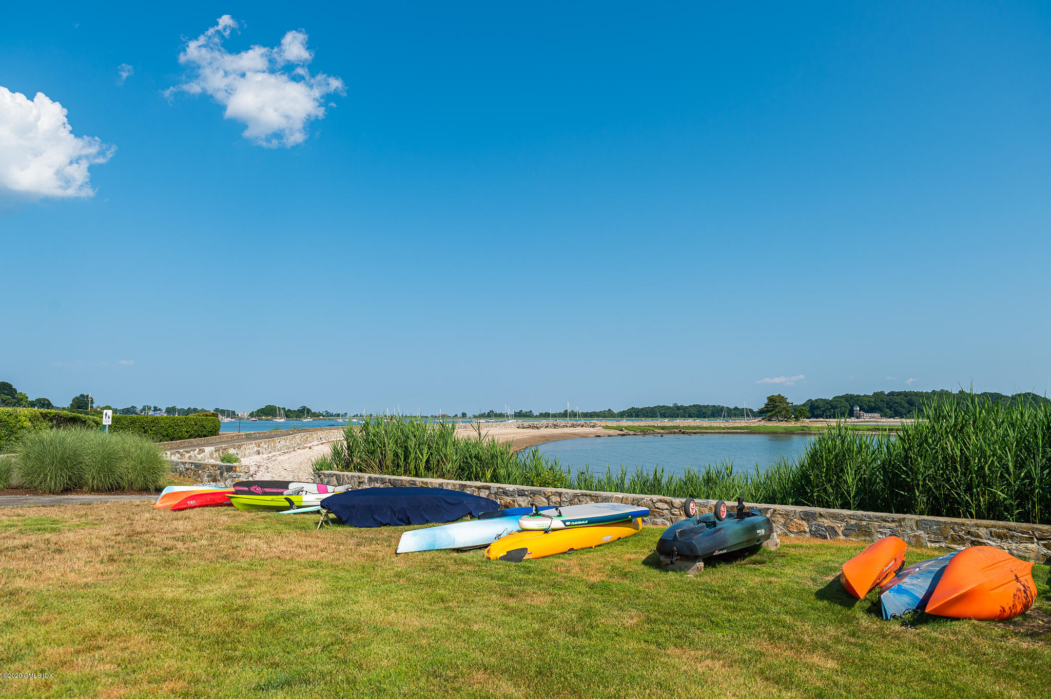 22 Pilot Rock Lane Riverside, CT 06878 - Photo 37 of 40 a view of a lake with lawn chairs and large trees