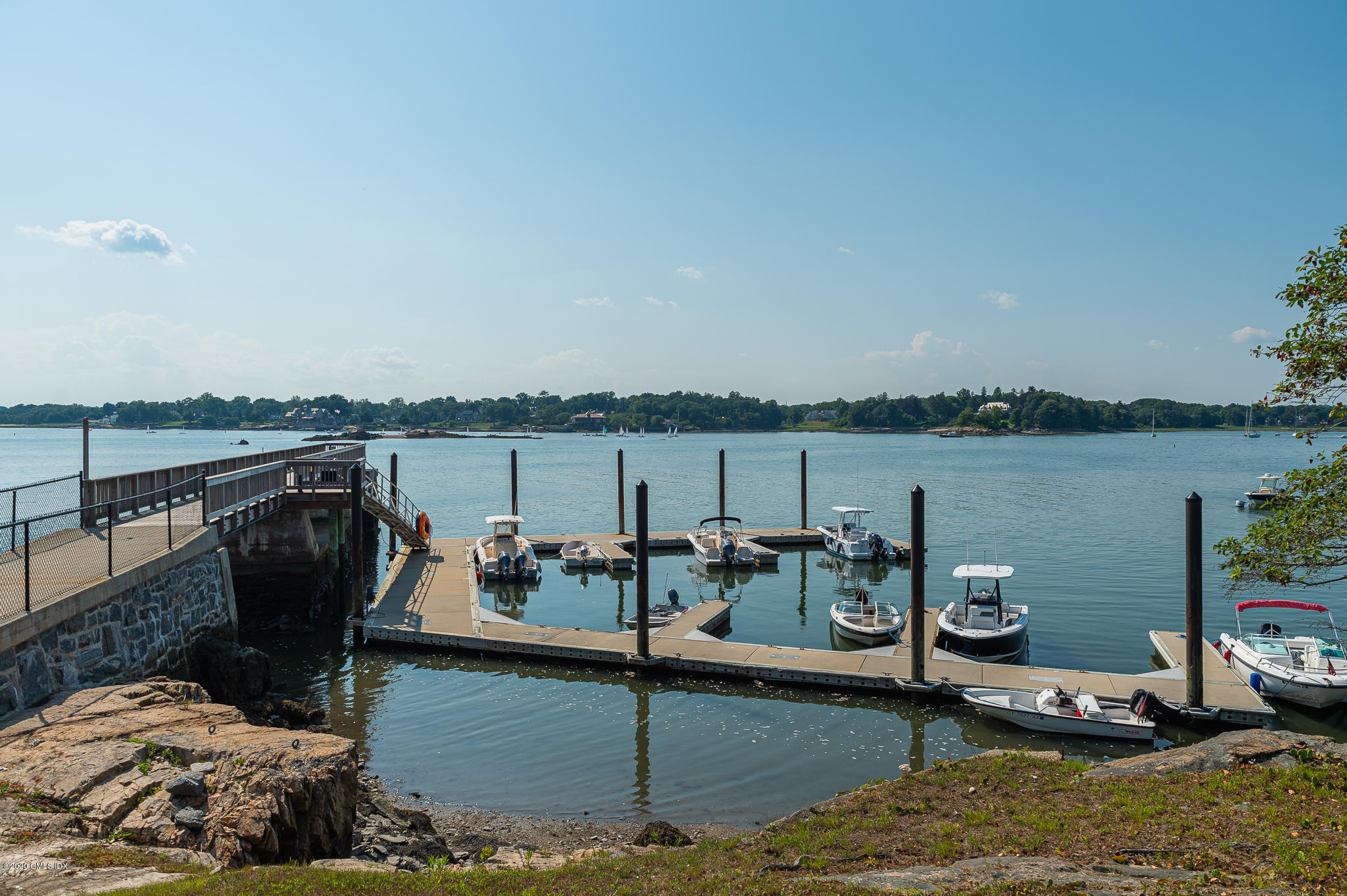 22 Pilot Rock Lane Riverside, CT 06878 - Photo 40 of 40 a view of a lake with couches chairs and an umbrella