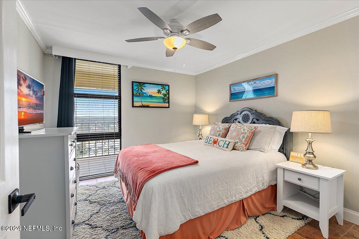 1301 1st Street South, Unit 1505 Jacksonville Beach, FL 32250 - Photo 13 of 36 a bedroom with a bed and a lamp on a dresser