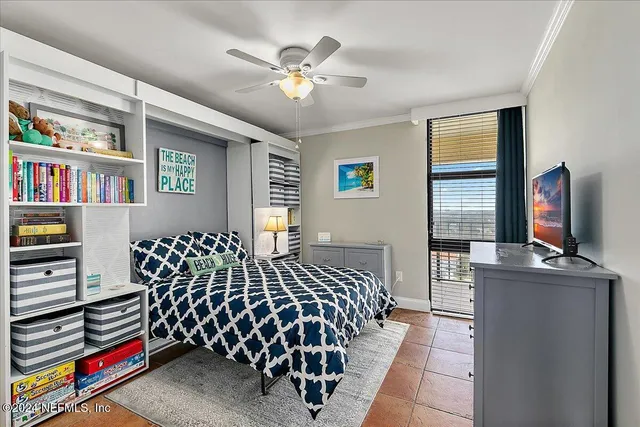a living room with furniture and floor to ceiling windows