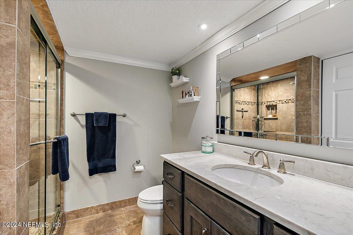 1301 1st Street South, Unit 1505 Jacksonville Beach, FL 32250 - Photo 17 of 36 a bathroom with a granite countertop sink toilet and shower