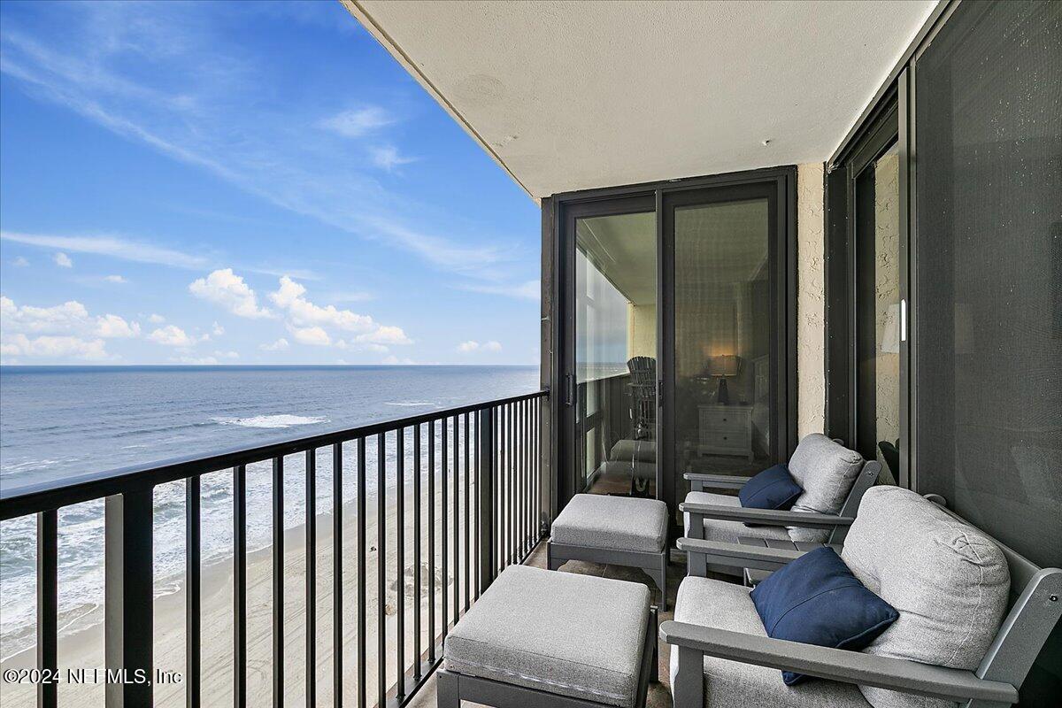 1301 1st Street South, Unit 1505 Jacksonville Beach, FL 32250 - Photo 4 of 36 a balcony with wooden floor table and chairs