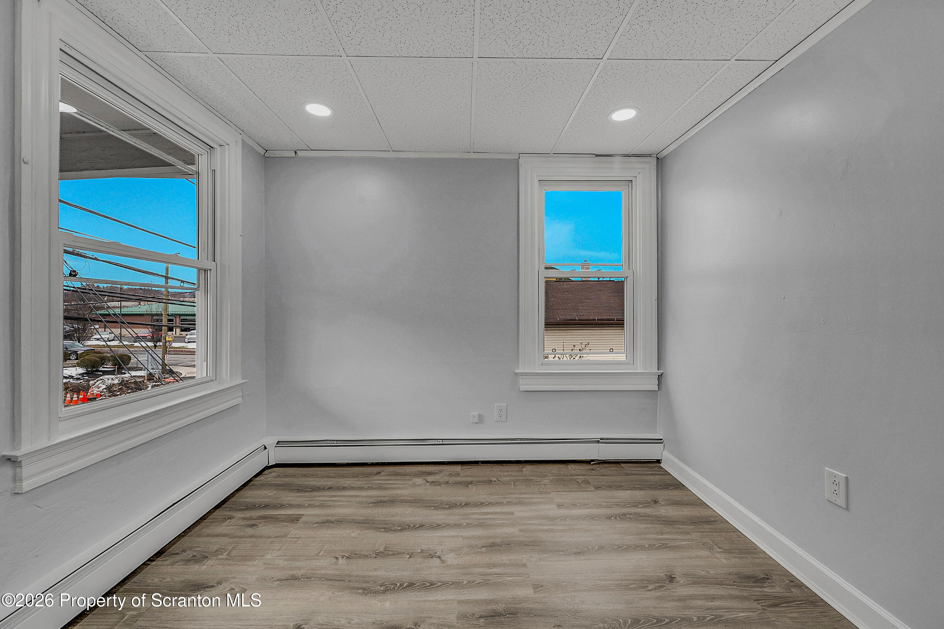 8 Green Ridge Street, Unit 2 Scranton, PA 18509 - Photo 6 of 18 a view of an empty room with a window and wooden floor