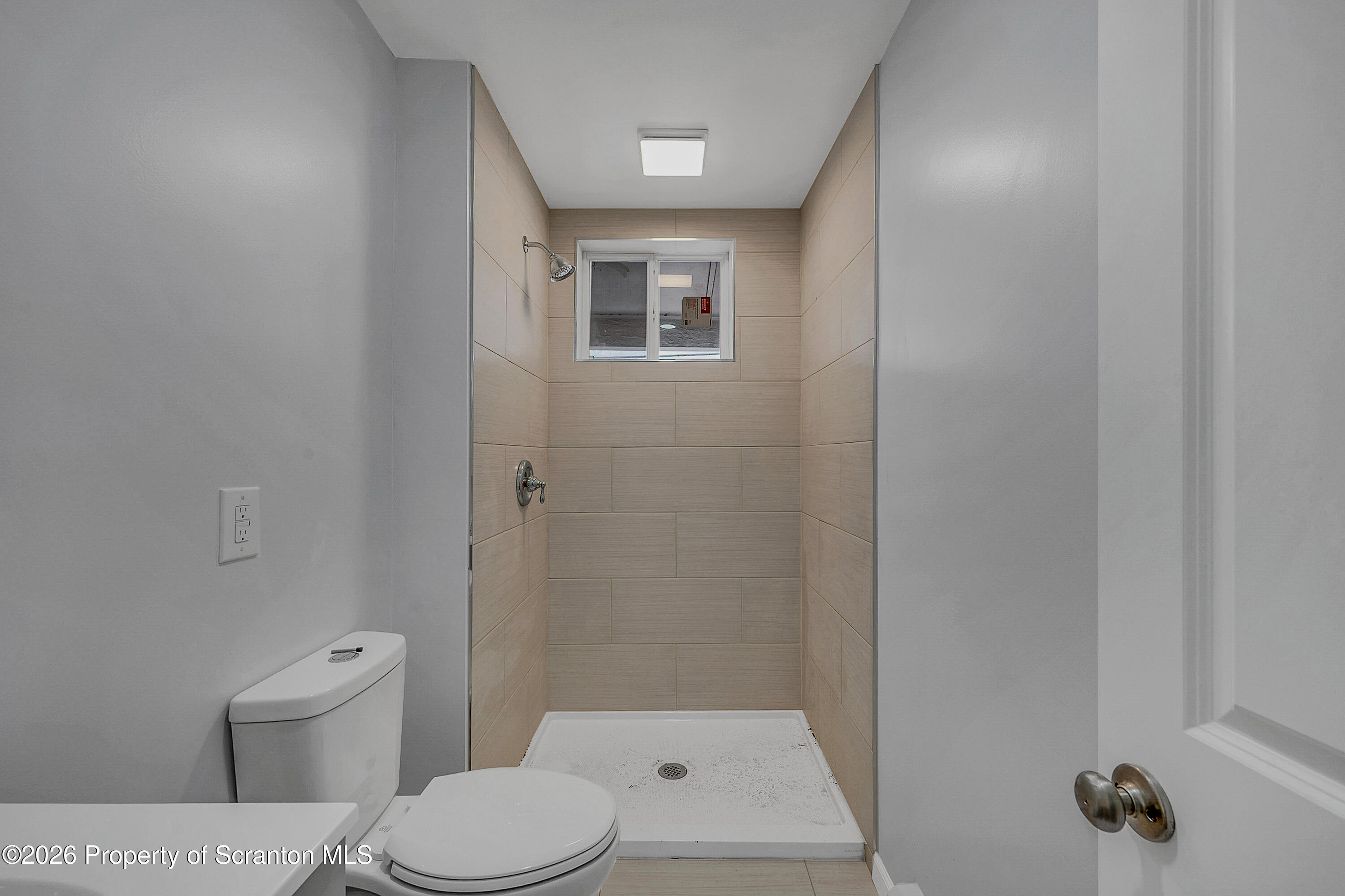 8 Green Ridge Street, Unit 2 Scranton, PA 18509 - Photo 9 of 18 a bathroom with a toilet a sink and shower