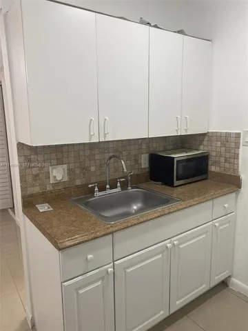 a kitchen with a sink and cabinets