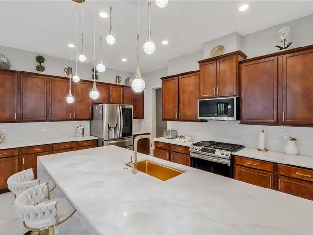 a spacious bedroom with a large bed and a chandelier
