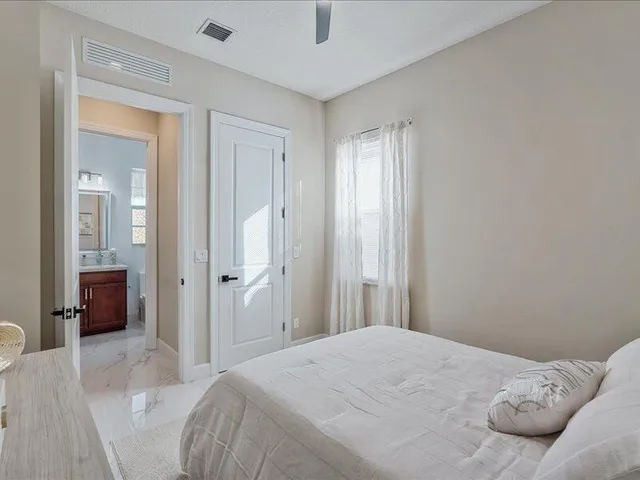 a spacious bathroom with a double vanity sink mirror and a bathtub