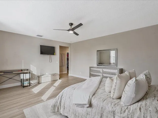 an aerial view of a swimming pool patio and outdoor seating