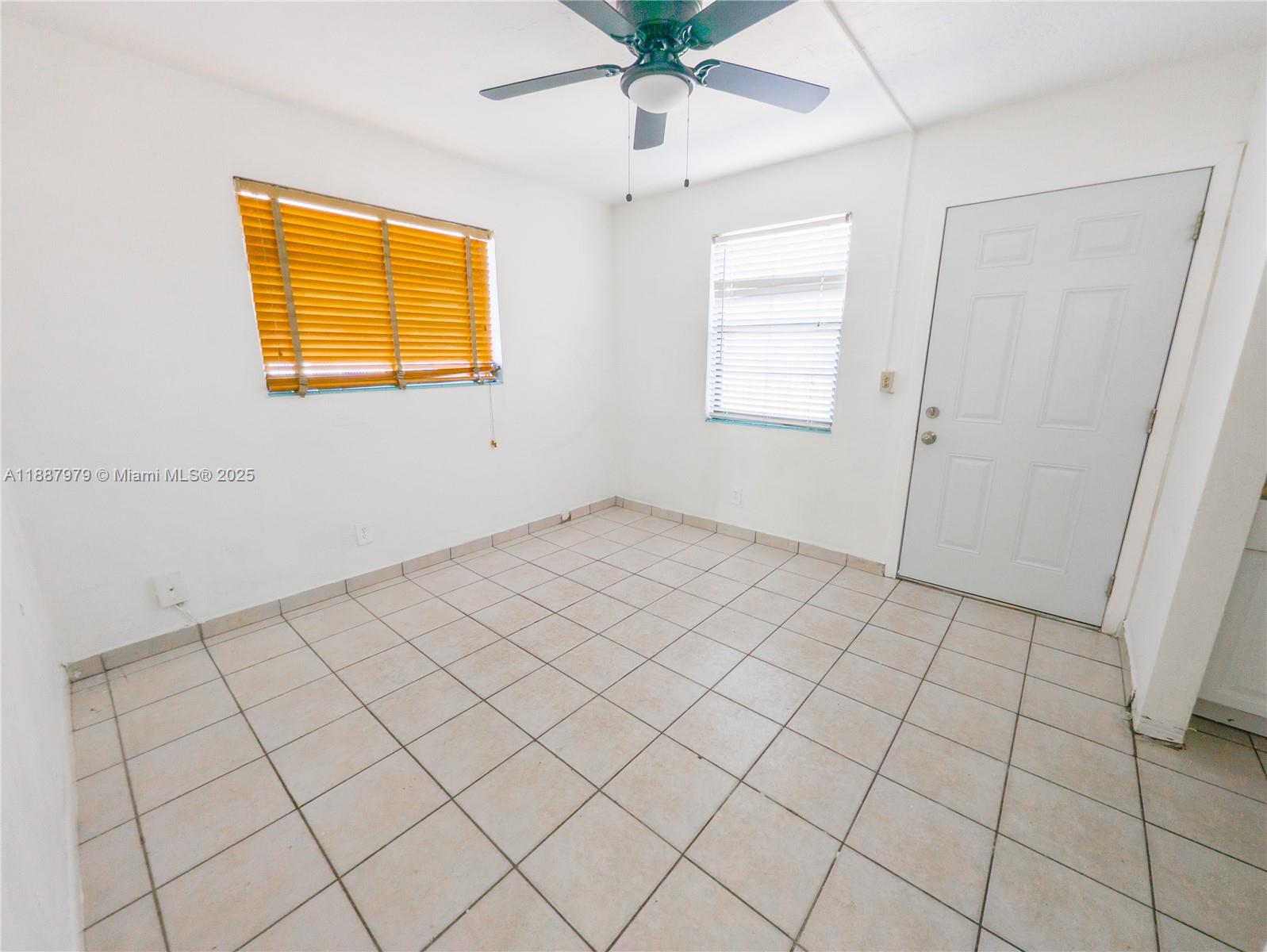1736 Northwest 19th Street, Unit 5 Miami, FL 33125 - Photo 2 of 9 a view of an empty room and window