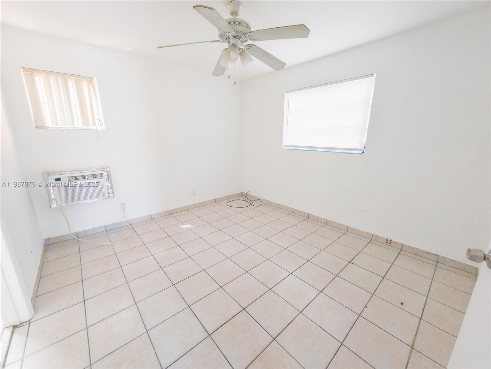 1736 Northwest 19th Street, Unit 5 Miami, FL 33125 - Photo 5 of 9 a view of an empty room and window