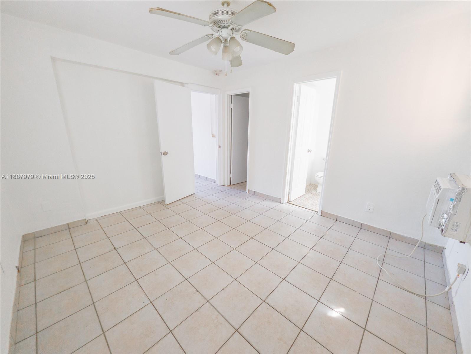1736 Northwest 19th Street, Unit 5 Miami, FL 33125 - Photo 6 of 9 a view of an empty room and window