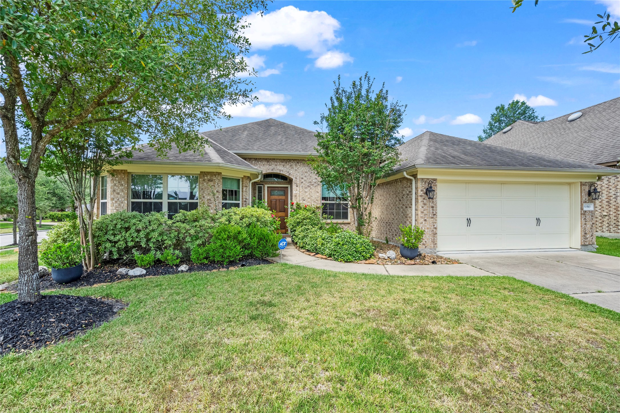 31503 Reston Cliff Court Spring, TX 77386 - Photo 4 of 28 a front view of a house with a yard and garage