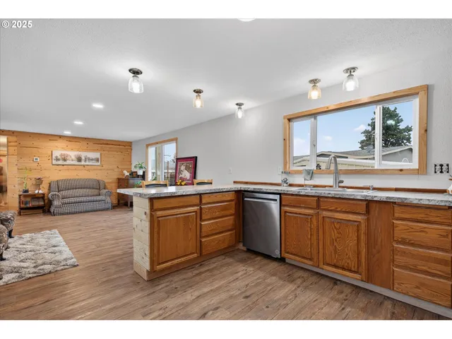 a kitchen with lots of counter top space and wooden floor