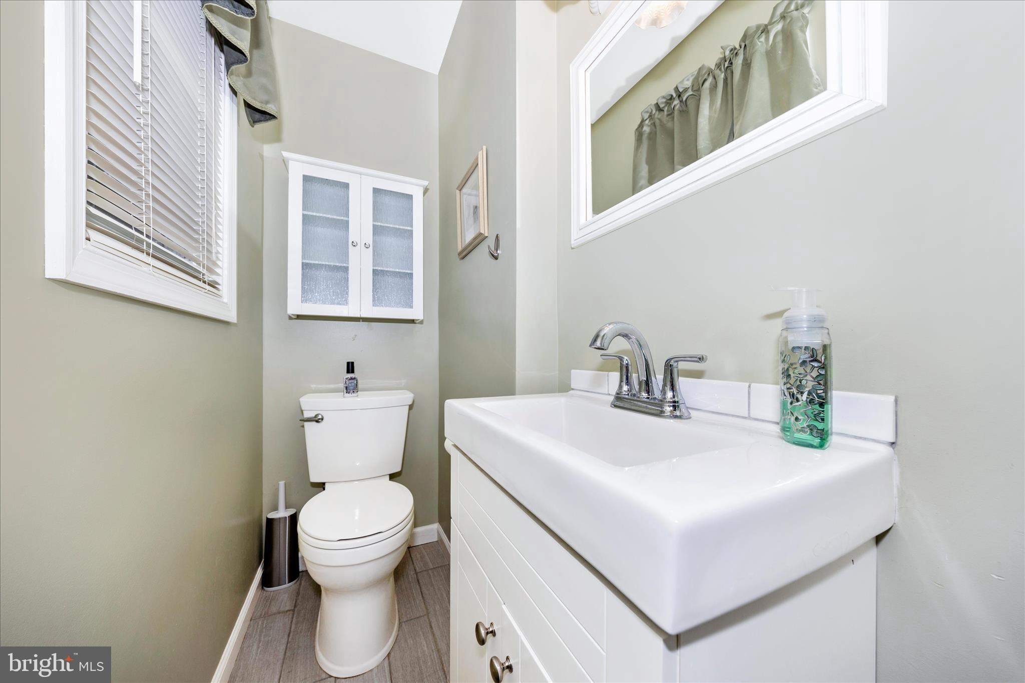 4432 Valley View Road Middletown, MD 21769 - Photo 18 of 54 a white toilet sitting next to a bathroom sink
